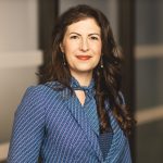 Suzanne Clark, BoD, Brain Injury Canada. Woman with long dark hair in a striped blue and white suit jacket.